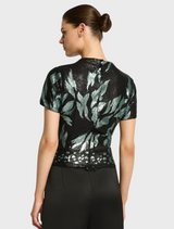 Back view of a woman in a black and green sequin top, showcasing the stylish Larissa Top Mint Black design.