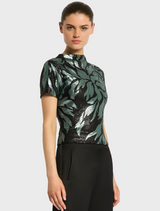 The model displays a black Larissa Top with wide-leg pants, highlighting a chic outfit.