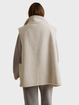 Cozy Sherpa cuddle gilet in latte shade, showcasing a soft fabric and sleeveless cut, ideal for chilly days.