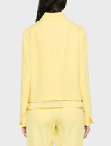 Layered effect jacket in yellow with button fastening, split cuffs, long sleeves, and two front flap pockets.
