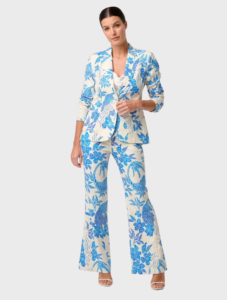 The image features a model in a blue and white floral suit, specifically the Leandro Contrast Lace Linen Viscose Blazer.