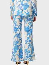 A woman wearing a blue and white floral suit, featuring the Leandro Contrast Lace Linen Viscose Stretch Pant in Azure Mosaic.