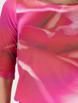 Leglet's pink T-shirt showcases a delicate all-over flower print, adding cheerful energy to any casual outfit.