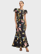 Elegant maxi dress with puff sleeves, adorned with a lemon vine print against a dark ebony fabric.