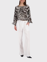 Stylish blouse featuring a leopard print, round neckline, and ⅞ trumpet sleeves, made from lightweight 100% viscose fabric.
