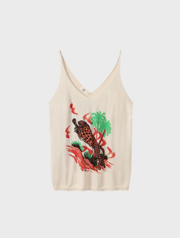 The image features a woman dressed in a white tank top paired with vibrant red pants, exuding a relaxed vibe.