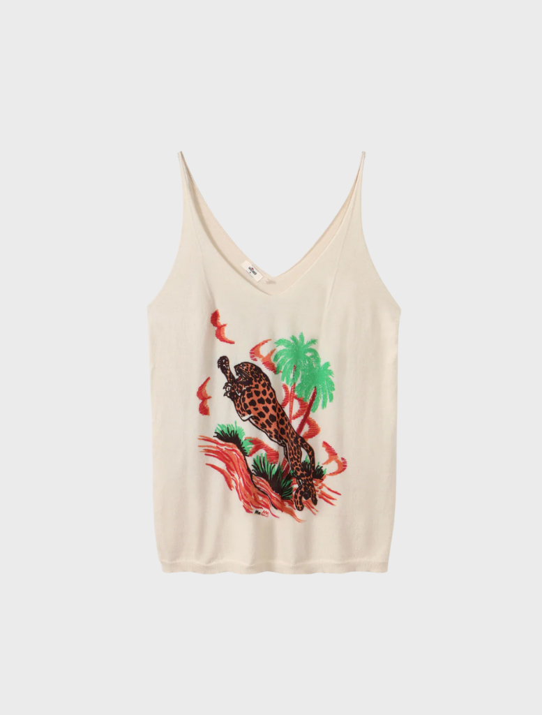 The image features a woman dressed in a white tank top paired with vibrant red pants, exuding a relaxed vibe.