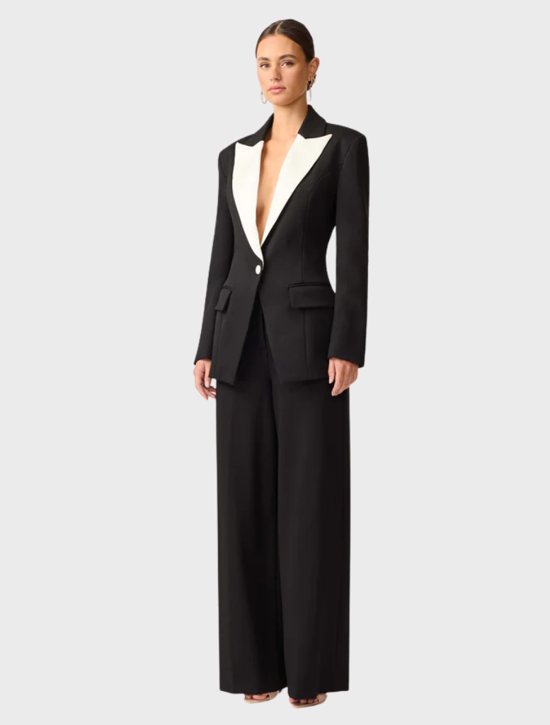 A black and white wool suit draped on a mannequin, illustrating its sophisticated design and craftsmanship.
