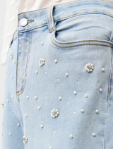 A pair of light blue wide leg jeans laid flat, highlighting their loose fit and soft denim fabric.