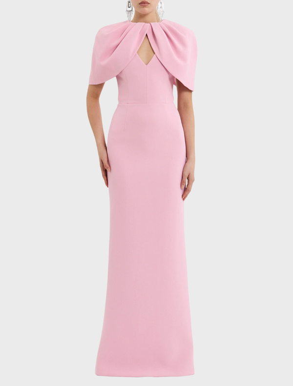Elegant light pink Xena gown hanging on a rack, showcasing its soft fabric and graceful design.