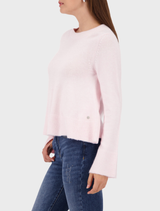 Flared sweater in light rose, showcasing a comfortable design with long sleeves and a gentle, flowing shape.