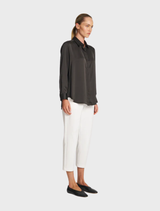 Soft mink shirt draped elegantly, featuring a relaxed fit and a warm, neutral tone.