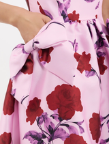 Lilac vintage rose Melora Midi Dress with a boat neckline, fitted bodice, drop waist bows, and a flowing circular skirt.