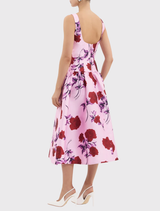Melora Midi Dress in lilac vintage rose features a boat neckline, fitted bodice, drop waist with bows, and a circular skirt.