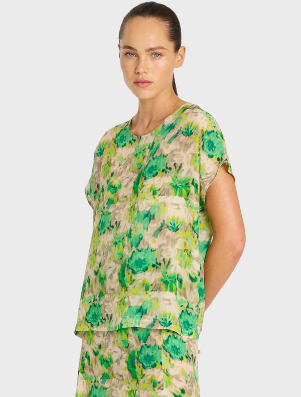 A short green dress with a floral print and a high-low hem, ideal for casual outings or warm weather events.