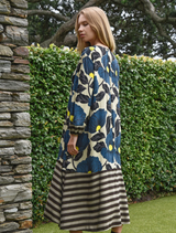 Soft satin dress in lime and blue floral design, with balloon sleeves and contrast panels for refined movement and style.