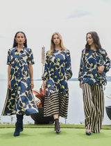 Feminine lime and blue floral satin dress with button front, gathered sleeves, and contrasting striped side panels for style.