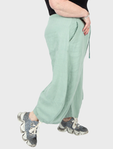 Lightweight linen trousers in a vibrant lime hue, featuring a relaxed silhouette ideal for summer outfits.