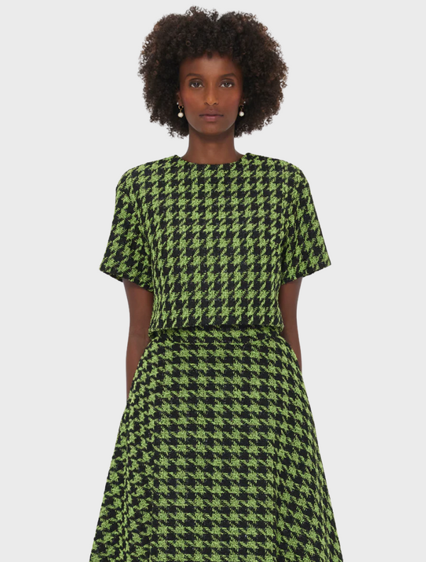 Green and black houndstooth dress made from a soft cotton blend, showcasing a classic pattern and stylish design.