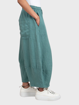 Grass linen trousers arranged neatly, emphasizing their breathable material and versatile design for various occasions.