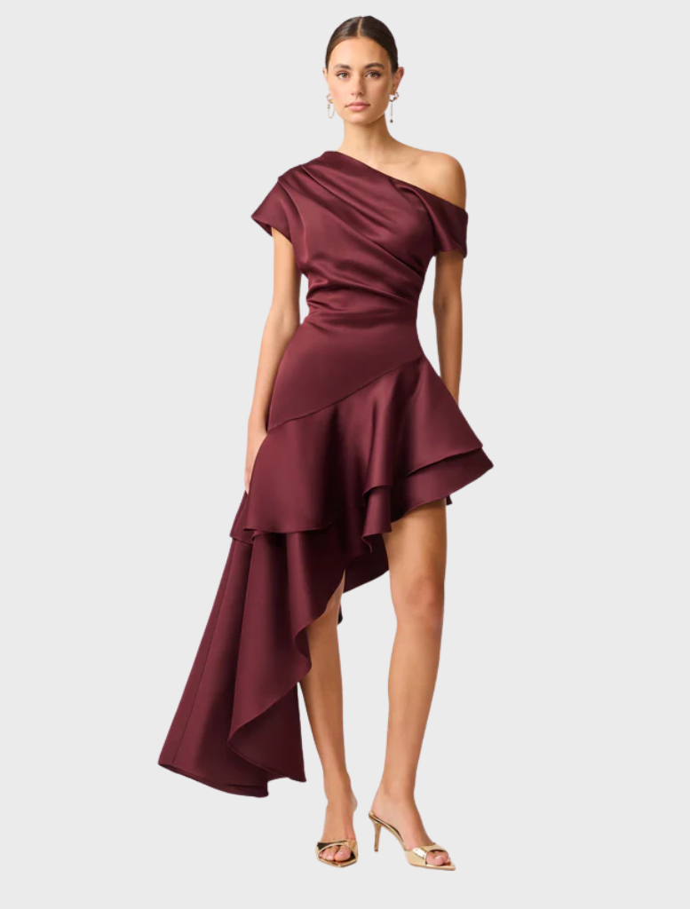 Elegant burgundy dress made of satin, designed with a unique asymmetric hem for added flair.