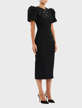 Chic black midi dress with a flattering cut and soft fabric, suitable for both casual and dressy occasions.