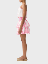 Shirred waist mini dress in a lively pink-and-white pattern, designed with adjustable straps and a flared skirt.