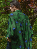 Green floral-patterned shirt displaying the slogan "Living The Dream" across the chest area.