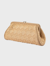 Natural beige woven clutch bag, Lois Woven Frame Bag,displayed hanging on a hook.