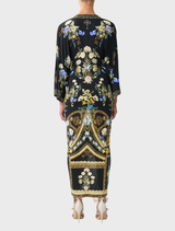 Elegant long dress with a split front and twist design, showcasing Ottoman-inspired style and refined draping.
