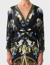 Long twist dress with a split front, embodying Ottoman elegance through its graceful design and flowing fabric.