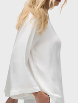  Ivory long-sleeve top with a slice neckline, offering a modern and sophisticated look for everyday wear.