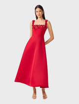 A red midi dress by Lucetta with a square neck and flared design, presented on a mannequin to emphasize its style.