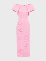 A pink dress showcasing a beautiful floral pattern, combining elegance with a touch of nature-inspired design.