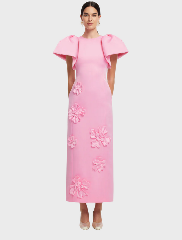  A pink dress featuring a vibrant floral pattern, showcasing a blend of colors and intricate designs.
