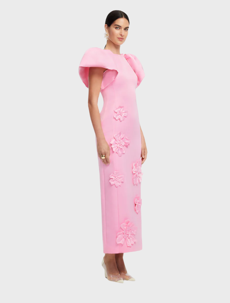 A pink dress with a colorful floral design, emphasizing its playful and stylish appearance.