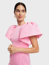 A pink dress showcasing a beautiful floral pattern, combining elegance with a touch of nature-inspired design.

