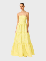 A vibrant yellow strapless gown showcasing a tailored bodice and a full skirt, suitable for elegant occasions.