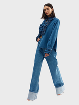 Flat lay of the denim Luna blouse, emphasizing its color and fabric details.
