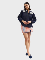 Indigo denim blouse featuring intricate lace detailing, designed for a stylish and elegant look.