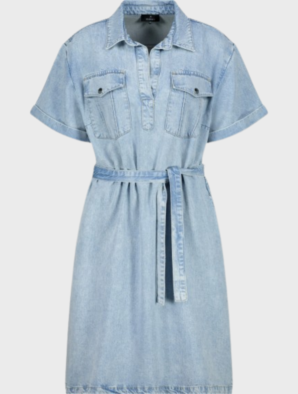 A woman in a stylish denim shirt dress featuring a collar, crafted from soft lyocell material