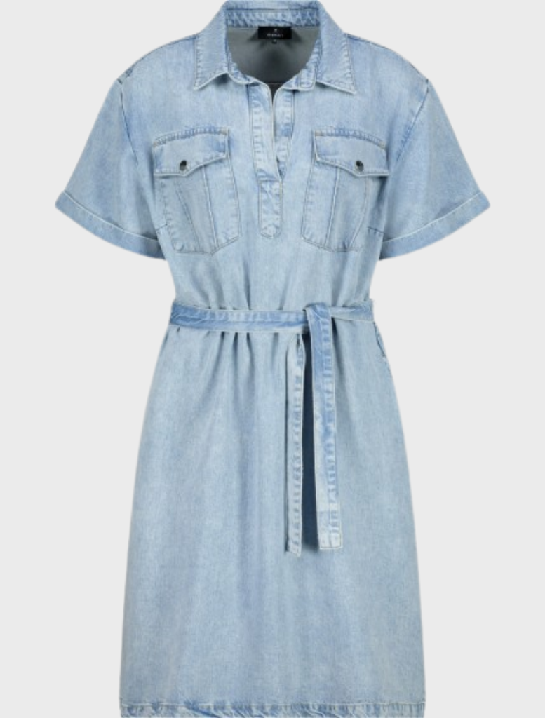 A woman in a stylish denim shirt dress featuring a collar, crafted from soft lyocell material