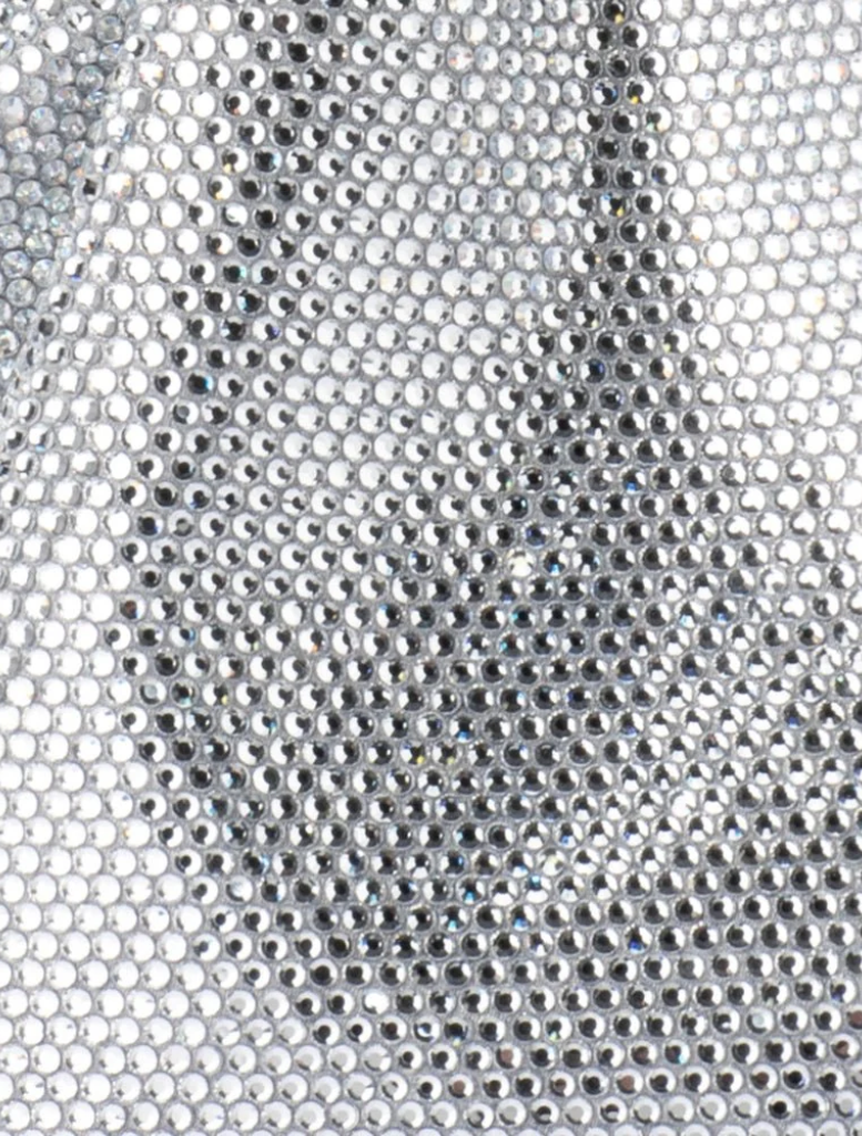 A fashionable silver purse with a distinctive metal handle.