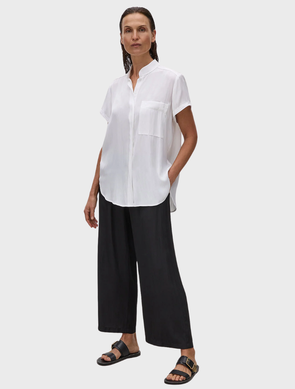 White Mache Stand Shirt displayed on a hanger, featuring a classic collar and button-down front.