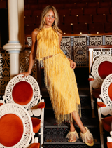 Chic Harvest Gold halter top with fringe detailing, perfect for elevating your occasion wardrobe for events and festivals.