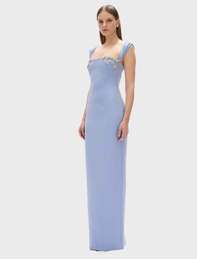 Beautiful blue Malia gown, characterized by its elegant lines and luxurious fabric, suitable for upscale events.