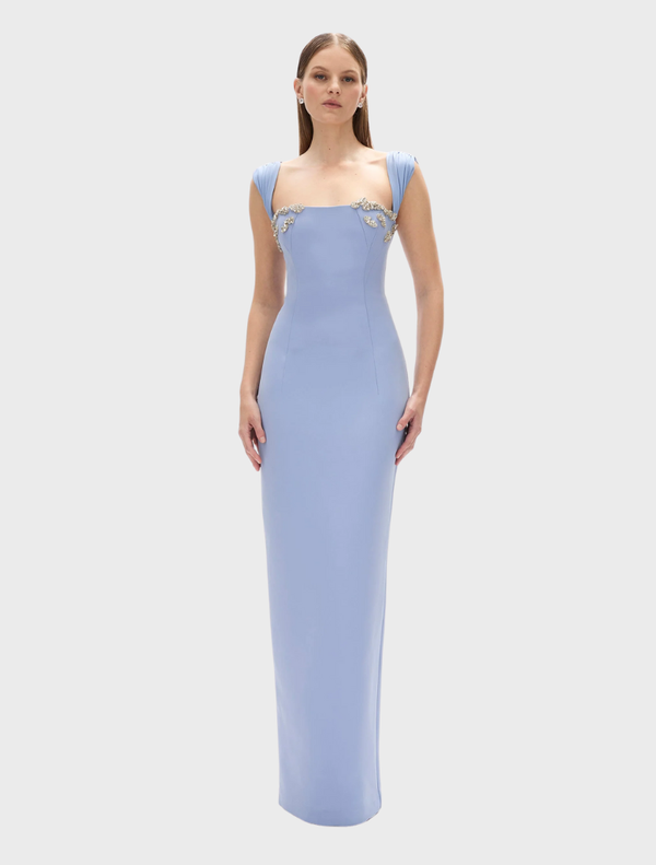 Elegant blue Malia gown featuring a flowing silhouette and delicate fabric, perfect for formal occasions.