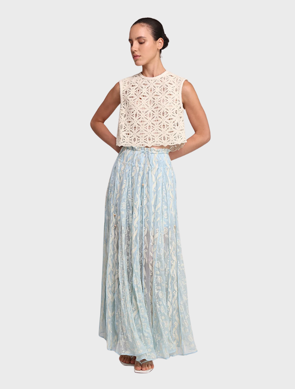 Aqua Malo Skirt displayed on a mannequin, showcasing its flowing design and vibrant color.