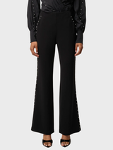Black viscose stretch pants with embellishments by Marcela Pearl, combining style and comfort.