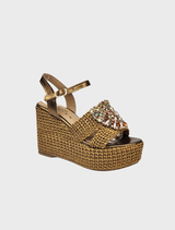 Women's gold wedge sandals with a buckle, showcasing a chic and elegant design.